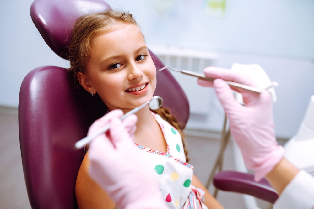 young girl receives pediatric dental care