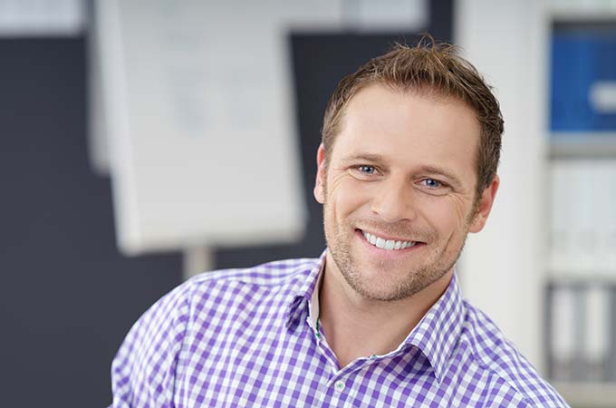 man smiling at the dentist