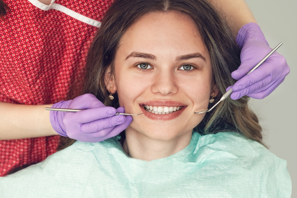 woman smiles in the dental chair